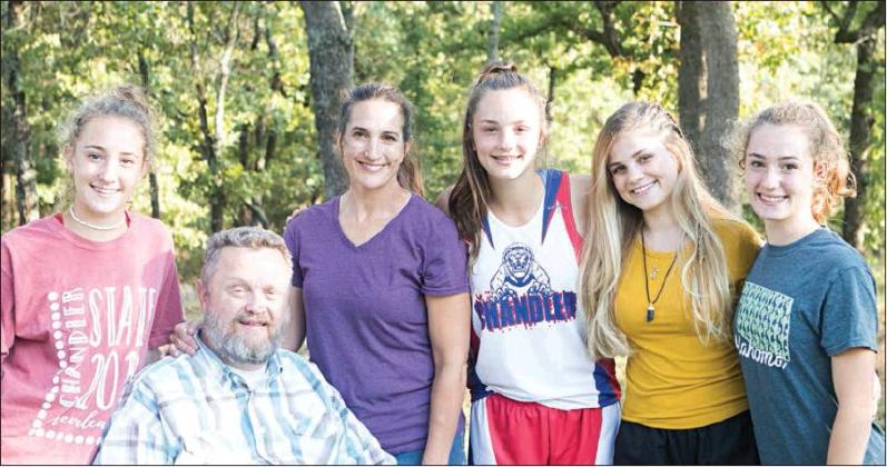 Exchange student Rachell Tahuney (yellow shirt) poses with Dale and Debbie Brannon and their triplets, Leah, Annie and Jessie, outside the Brannon home. See Rachell’s story on Page 3A. Photo/ Jessica Pollard