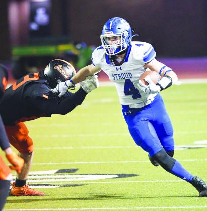 Stroud’s Jacob Beck (4) sheds a would-be tackler during the state quarterfinals Friday night at Moore High School. Photo/Brian Blansett