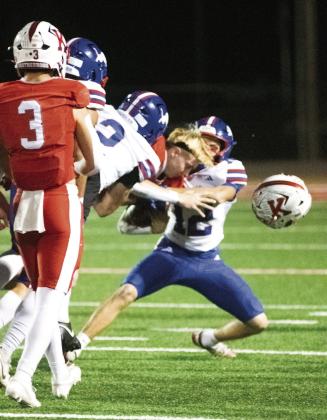 Indicative of the physical nature of the game, was this first-quarter play, when hits from Clayton Ritchie (12) and Coniah Ritchie (2) sent the helmet of Kiefer’s Brody Baxter flying. Photo/Brian Blansett