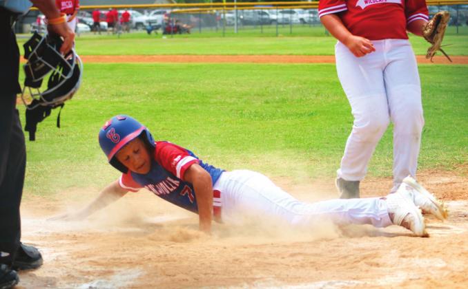Pictured to the right, Bryson Taylor slides into home plate. Photos/Misty Harelson.