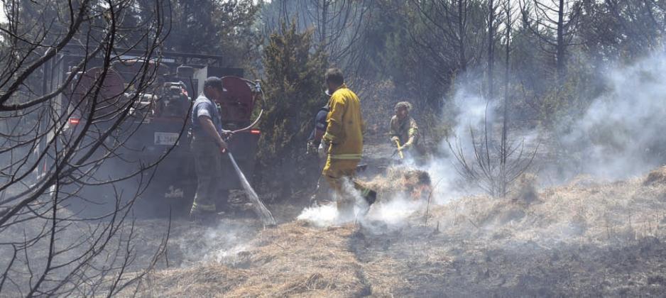 Firefighters work to put out a hay bale at a large grassfire near Kendrick on Aug. 20. Seven fire departments responded to the call. Photo/Emily Kalka