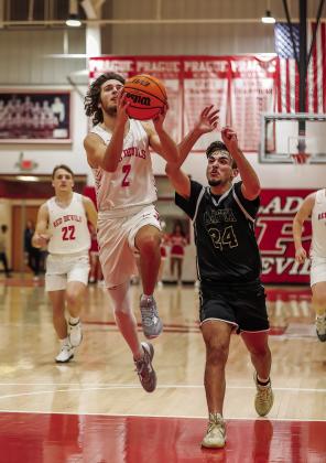 Above, Peyton Ezell drives for a shot during No. 6 Prague’s 51-36 win over Latta. Photo/Rick Hester