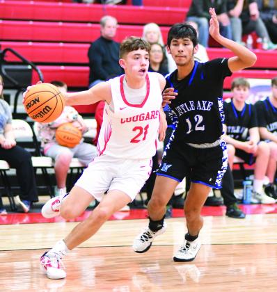 North Rock Creek senior Jordan Coody (21), shown here in the Cougars’ win over Little Axe last week, hit the 1,000-point mark for his career Friday night when he scored on a mid-range jumper in the third quarter at Bethel. In addition to being a four-year starter in basketball, Coody has been a multi-sport standout, making All-State in cross country every year since he was a freshman. Photo/Brian Blansett