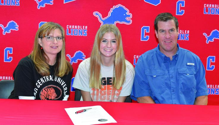 Chandler senior Cassie Wright, shown with parents, Shawna and Jeremy Wright, signed a letter of intent Tuesday to run cross country at East Central University in Ada. She recently medaled at the state meet and was named a Class 3A All-Star. Photo/Brian Blansett