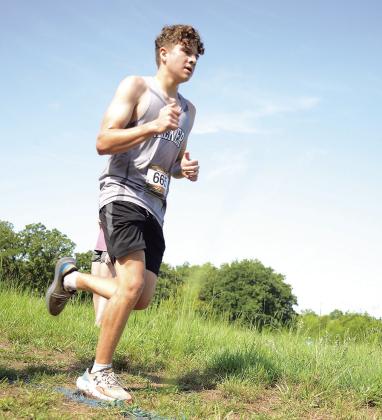 Above, Chandler’s Cooper Snovel makes the turn into the final 400 meters of the Stroud cross country meet on Saturday. He finished with a time of 11:55.9. Above right is Cooper Emmons from Davenport, who clocked an 11:54.5. Middle right, Chandler’s Tatum Crouch (883) is past the mid-point of the race en route to a time of 6:52.5. Left, Jaelynn Alspaugh from Stroud finished in 6:36.8. At right, Hunter Harness from Meeker finished with a time of 12:59.6. Photos/Brian Blansett