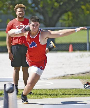 Above, Peyton Davis from Stroud, shown in the 100-meter hurdles, won three state championships and broke three state records at the Class 2A track meet. Photo/Beth Young. Below left, Chandler sophomore Eli Smithey harvested gold in the Class 3A shot put. Photo/Brian Blansett. Below right, Davenport’s Amarie Bobo took the gold in the Class A shot put. Photo/Beth Young. For more on area sports, please see Section C.
