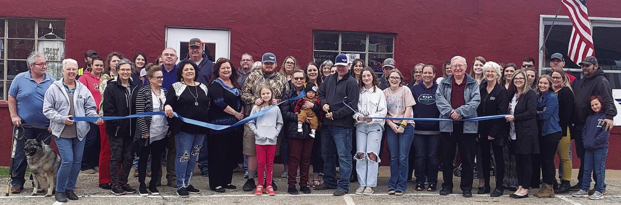 Darin Sherman, center, cuts the ribbon on the 66 Emporium, 109 W. 11th Street, last week during ceremonies for the opening. The ribbon cutting was sponsored by the Greater Chandler Chamber of Commerce. Photo/Baylee Blancarte