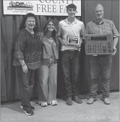 Braxton Roberts from Bethel FFA was the recipient of the 2025 Ann “Sis” Gilbert Outstanding Junior at the Fair Award. Pictured from left, are Suzanne Gilbert, past recipient Poppy Robinson, Braxton Roberts and Randy Gilbert.