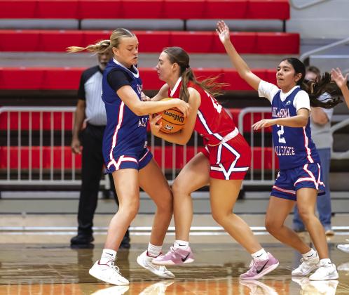 Ava Bell (left) plays harrassing defense by tying up the ball with the West’s Conley Cayot (OBA) Photo/Rick Hester