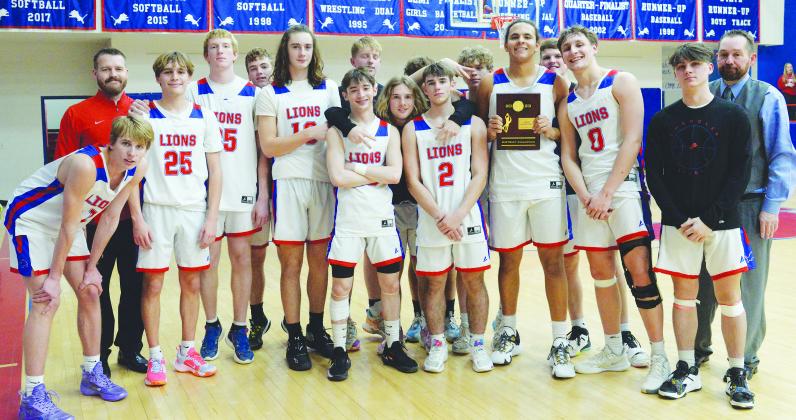 The Chandler Lions pose with their district championship trophy after beating Beggs, 55-46, Friday. Now 13-10 for the season, the Lions will play Washington Thursday night.