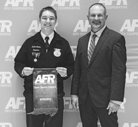 Wellston sophomore Kaden James stands with AFR Cooperative Vice President Ryan Plemmons after placing first in the Intermediate AFR/ OFU category at the AFR State Speech Contest. The competition took place in Stillwater on Dec. 2.