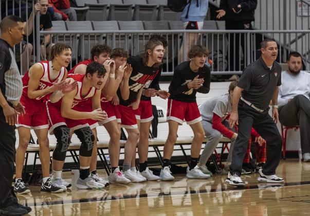 The Prague bench exhorts the defense to hold a lid on Meeker scoring just before the end of the half last Friday in Meeker. The Red Devils took a 63-47 victory over the Meeker boys and won the girls game, 65-37. For more basketball from last week, see Page 3C. Photo/Rick Hester.