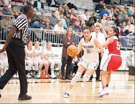 Below right, Meeker senior Halle Calvillo heads for the lane against McLoud in the Lady Bulldogs’ season opener. Photo/Brian Blansett