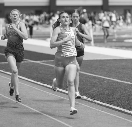 Wellston’s Savanah Gaylord competes in the 800 meter run at the Skordle Relays in Cashion. To her left is Blaklei Smith from Chandler. Photo/Mario Holland