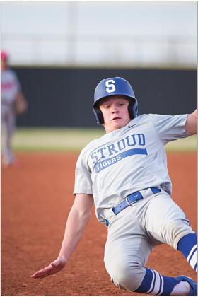 Drew Elerick slides into third base in an attempt to steal. Photos/Brian Blansett