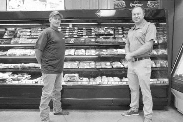 Sheldon Hurst and Anthony Buoy, right, at the meat case at Anthony’s Foods in Meeker. Photo/Brian Blansett