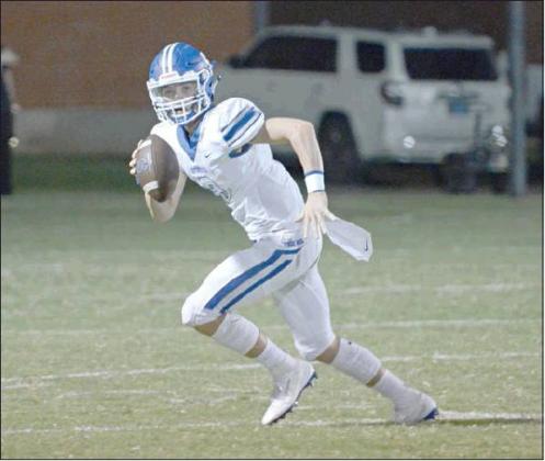 Stroud quarterback Grant Elerick rolls out to pass against Wayne. Photo/John Denny Montgomery