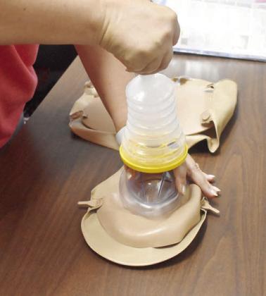 Park Road School Nurse Jacalyn Allen demonstrates how to use the new LifeVac device the school has just received. It helps to safely and effectively dislodge food or other items from an aspirating person. There will be one device in both cafeterias in Chandler Public Schools. Photos/Emily Kalka