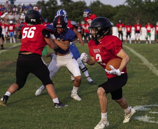 Several area athletes participated in the Citizen Potawatomi All-Star football game Friday night at Bethel. At left, Meeker’s Jason Brewer fights through contact for a reception. Top, Chandler senior Ethan Manning (red shirt) rushes the passer and, above, Davenport’s Colton Vanfossen returns a punt. Ty Gabbert and Braden Harris from Meeker, Jeremy Galbraith form Chandler and Kyle Guest and Devin Denton from Stroud also played. The North won, 13-9. Photos/Rick Hester