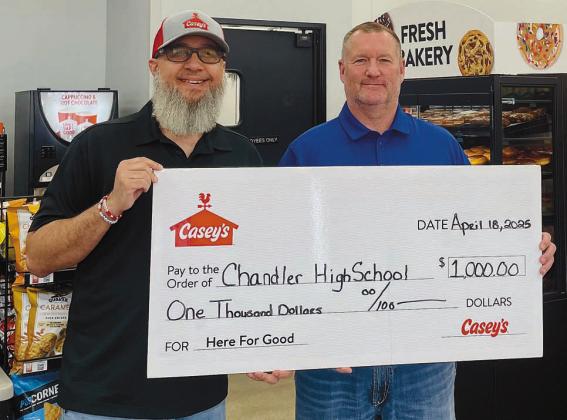 Casey’s District Manager Jared Morrison presents a check for $1,000 to Chandler High School Principal Geoff Metheny. Photo/provided