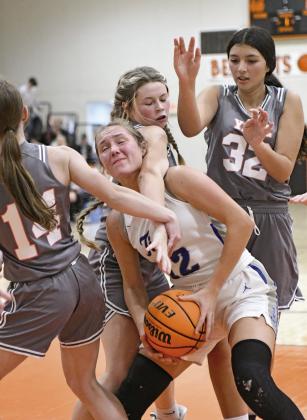 Above, Blestin Miller (3) lays up a shot in the first half of Prague’s win over McLoud Saturday night. Defending is Luke Norwood, with McLoud’s Tryce Lewis (50) and Prague’s Trevor McGinnis (23) at the edge of the lane. Photo/Brian Blansett. Below left, Wellston’s Lane Kulp (11) drives against Woodland in the finals of the Agra tournament. Photo/Jeremy Self. Below right, Stroud’s Makenna Hall (12) absorbs a mauling in the lane during the Lady Tigers win over Yale. Photo/Brian Blansett