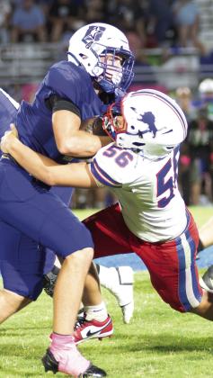 Chandler’s Ray Evans (56) stops Dickson running back Easton Peoples. Photo/Brian Blansett