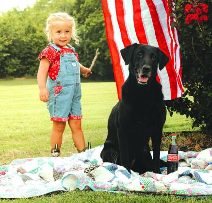 Millie and Bailey enjoy a summer day with a refreshing bottle of Coke. Photo/ Emmie Smith