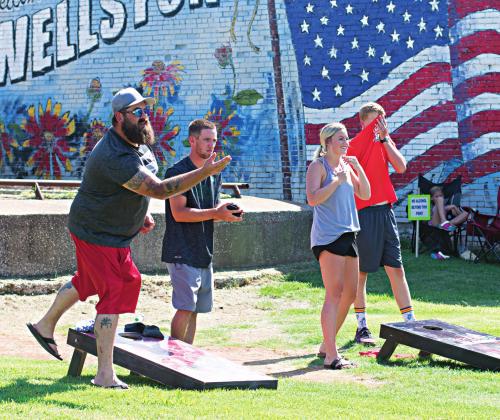 Bags fly during the cornhole tournament at the inaugural Deep Fork River Festival in Wellston. For story and more photos, see Page 8B. Photo/Chelsea Weeks