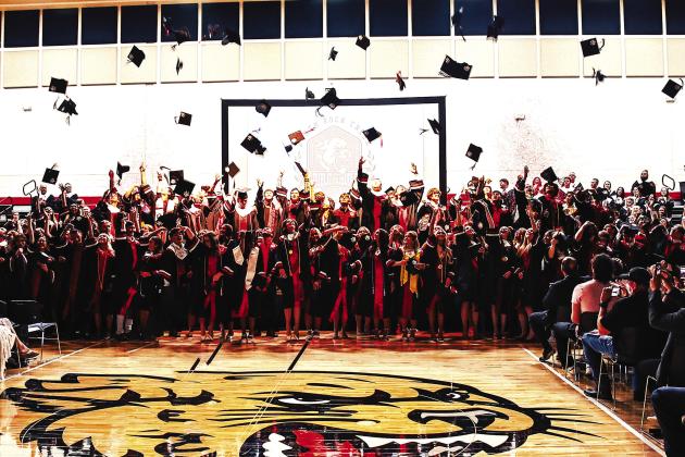 North Rock Creek’s graduating class ends Thursday evening by tossing their hats into the air. Photo/Sheryl Gowin