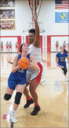 Jadyn Young (12) drives for the game-winning bucket in overtime. Photo/ Brian Blansett