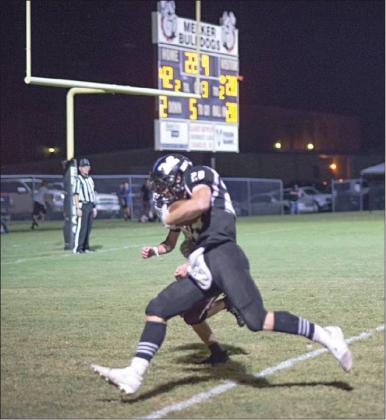 Caden Wolford carries a would-be Kellyville tackler across the goal line on the last of his five touchdown runs Friday night. Photo/Brian Blansett