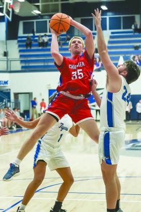 Left, Ajay Lynch (11) turns the corner on Prague’s Blestin Miller (3). Photo/Robyn Miller. Above, Chandler’s Alec Jackson goes up against Stroud’s Kason Presley (24). Photo/Mario Holland. All four schools were playing in the 66 Conference tournament in Okemah.