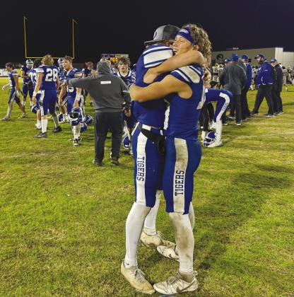 Aiden Collins, right, gets a congratulatory hug from Jacob Beck after Stroud’s 49-14 win in the state quarterfinals Friday night. Photo/Brian Blansett