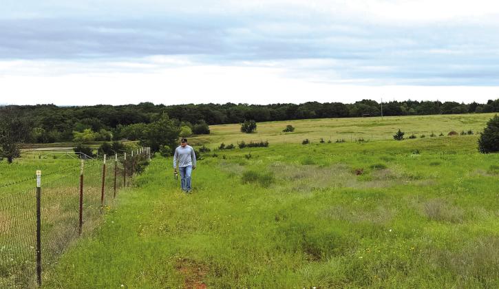An intern from Arcadia walks the fence line while out with Lincoln County Game Warden Jacob Harriett. Photo/ Andrew Frazier