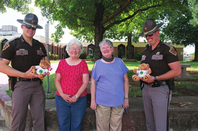 Pictured from left to right: Trooper Brody Carls, Oklahoma Home and Community Education Lincoln County President Eileen Steenwyk, Agra OHCE President Janelle Wilkinson and Trooper Adam Post stand with the donated teddy bears. Photo/Chelsea Weeks
