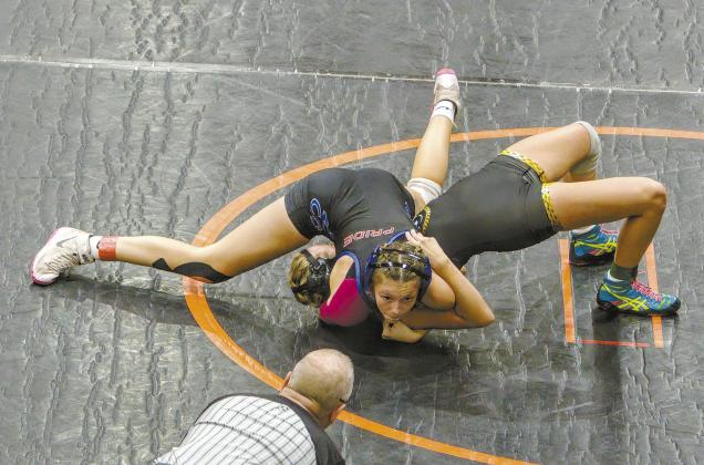 Chandler wrestler Shailey Penn looks for the referee to signal a pin during the First Annual Kyle Sam’s Memorial Open Tournament in Cushing on Nov. 9. She placed first in her weight category (120-125 pounds) and is one of six girls on Chandler’s Wrestling Team. Photo/Jennifer Pryor