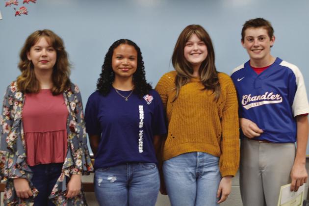 Left, President Marilyn Young presents Jana Telford a certification in recognition of 40 years membership in the Delta Kappa Gamma Society International. At right are essay winners, from left, Katherine Barnett, Karyss Campbell, Royanna Berry, Rhett Haley.