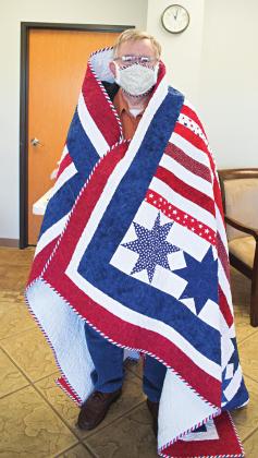 At left is quit recipient Virgil Mangus. Pictured below are two of the quilts. Photos/Brian Blansett