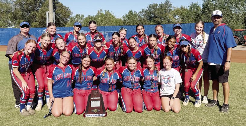 Above, Chandler’s Lady Lions pose with their trophy after the Class 3A fastpitch state finals in Oklahoma City. Below, Ruthie Capps slides safely into second base during the championship game against Washington. File photos/Brian Blansett