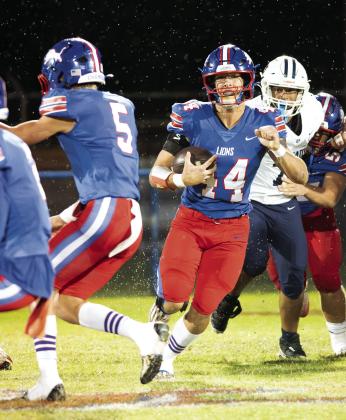 Roanon Wolford runs through raindrops and Casady tacklers en route to a long gain in the first half. Photo/Brian Blansett