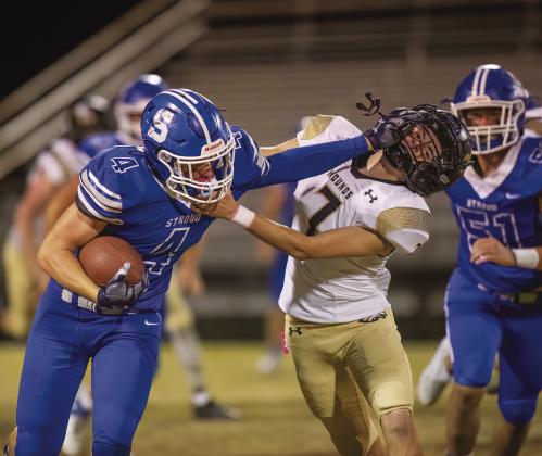 Jacob Beck provided the visual metaphor for the Tigers’ win by shoving aside a would-be tackler from Mounds. Beck ran for 50 yards and scored the Tigrs’ first touchdown. Photo/Rick Hester