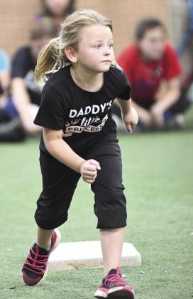 Athlete in the recent Chandler Softball Camp moved indoors for the Wiffle ball games. Above, Maguire Hubbard from Stroud makes a play for an out at first base. Left, Alivia Keller from Chandler takes off from second base. Right, Joy Alsip from Chandler took advantage of breaks in the action to work in some handstands and cartwheels. Photos/Brian Blansett