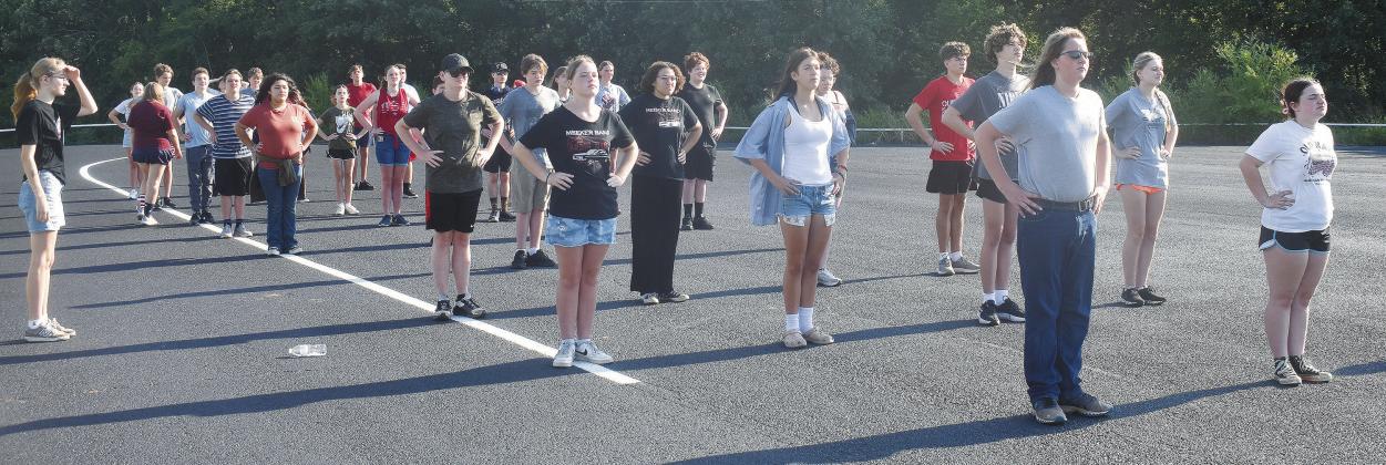 The Pride of Meeker marching band lines up to go through marching drills in the parking lot next to the high school with Drum Major Holly Turner (far left) looking on. The band is 42-strong this year, and ready to hit the field and competitions. Photo/Emily Kalka