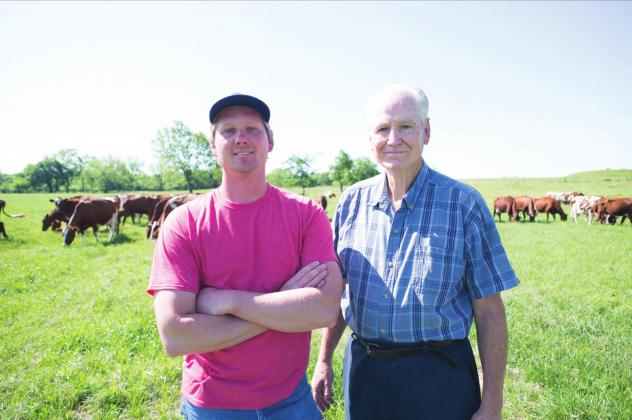 Travis and Steve Marak, with their Shorthorn herd grazing behind them. Photo/Brian Blansett