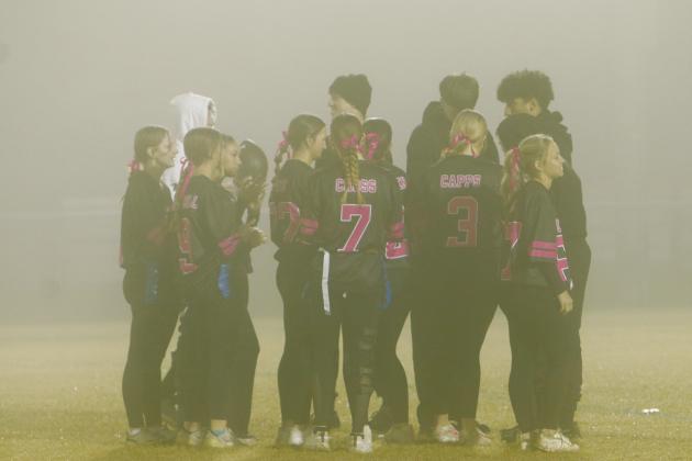 It was a foggy scene as members of the Senior Team huddled up during Chandler High School’s annual Powder Puff Championship on Nov. 24 at Joe Telford Field. The team defeated the Freshmen in its first game and made it all the way to the final game against the Juniors. The Seniors ultimately took home the trophy, even with visibility questionable throughout the night. Photo/Jennifer Pryor