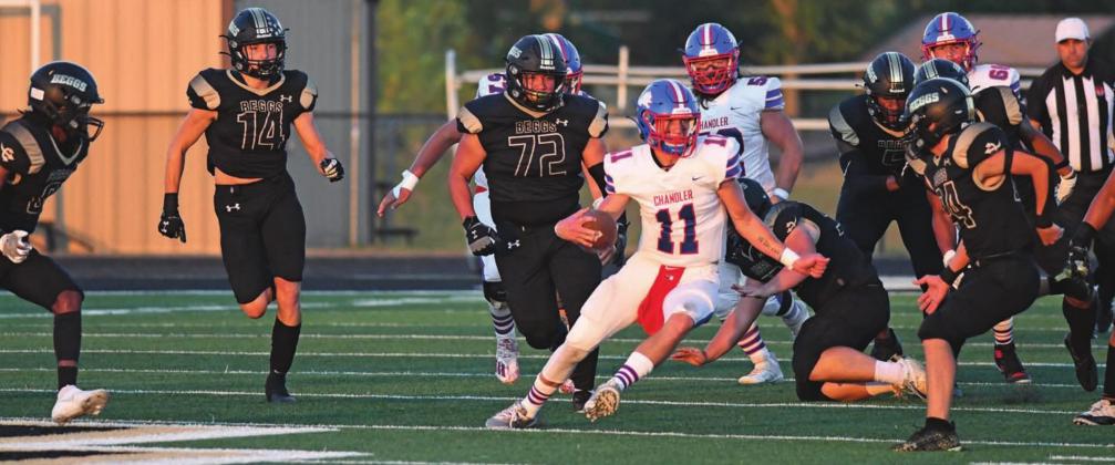 Chandler quarterback Kaden Jones makes an open-field cut as the Beggs defense tries to close in on him during the first half Friday night. Photo/Brian Blansett
