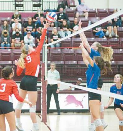 Right Hope Hanna scores a point for the Lady Cougars against Oklahoma Christian School.