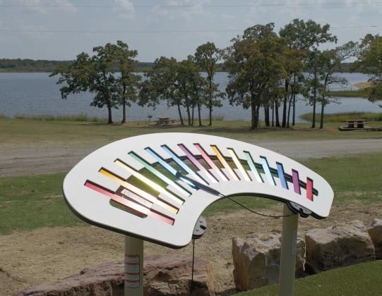 Above is a view of the new playground that was recently installed at Stroud Lake. The playground was part of a grant that also funded new equestrian campsites. The playground features ADA accessible play equipment, along with soft turf for barefoot children. Below is a close-up of the music station at the playground. It features a xylophone and musical pipes. Photos/Emily Kalka