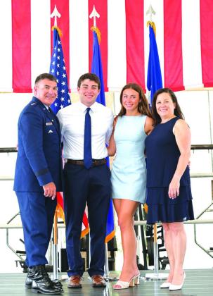 Maj. General Matthew Wolfe Davidson (left) poses with his children (center) and wife (far right) at his retirement ceremony in June. Photo Provided By Matthew Wolfe Davidson