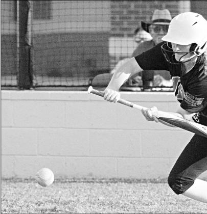 North Rock Creek’s Haley Hacker puts down a bunt on Thursday in the Lady Cougars’ game against Heritage Hall. Photo/Brian Blansett